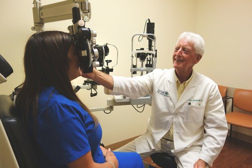 Dr. Branton, therapeutic optometrists at Lusk Eye Specialists giving patient eye exam