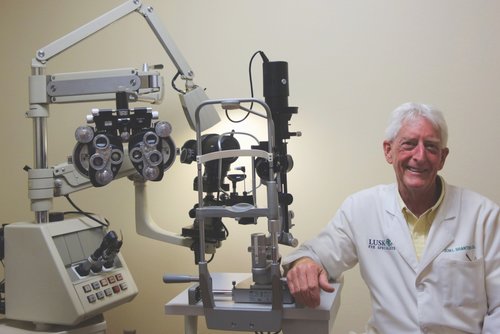 Dr. Jon Branton, optometrists in Shreveport, LA with eye exam machine