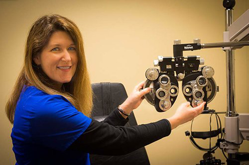 Dr. Theriot, Founder and Director of Dry Eye Center at Lusk Eye Specialists, with eye test machine